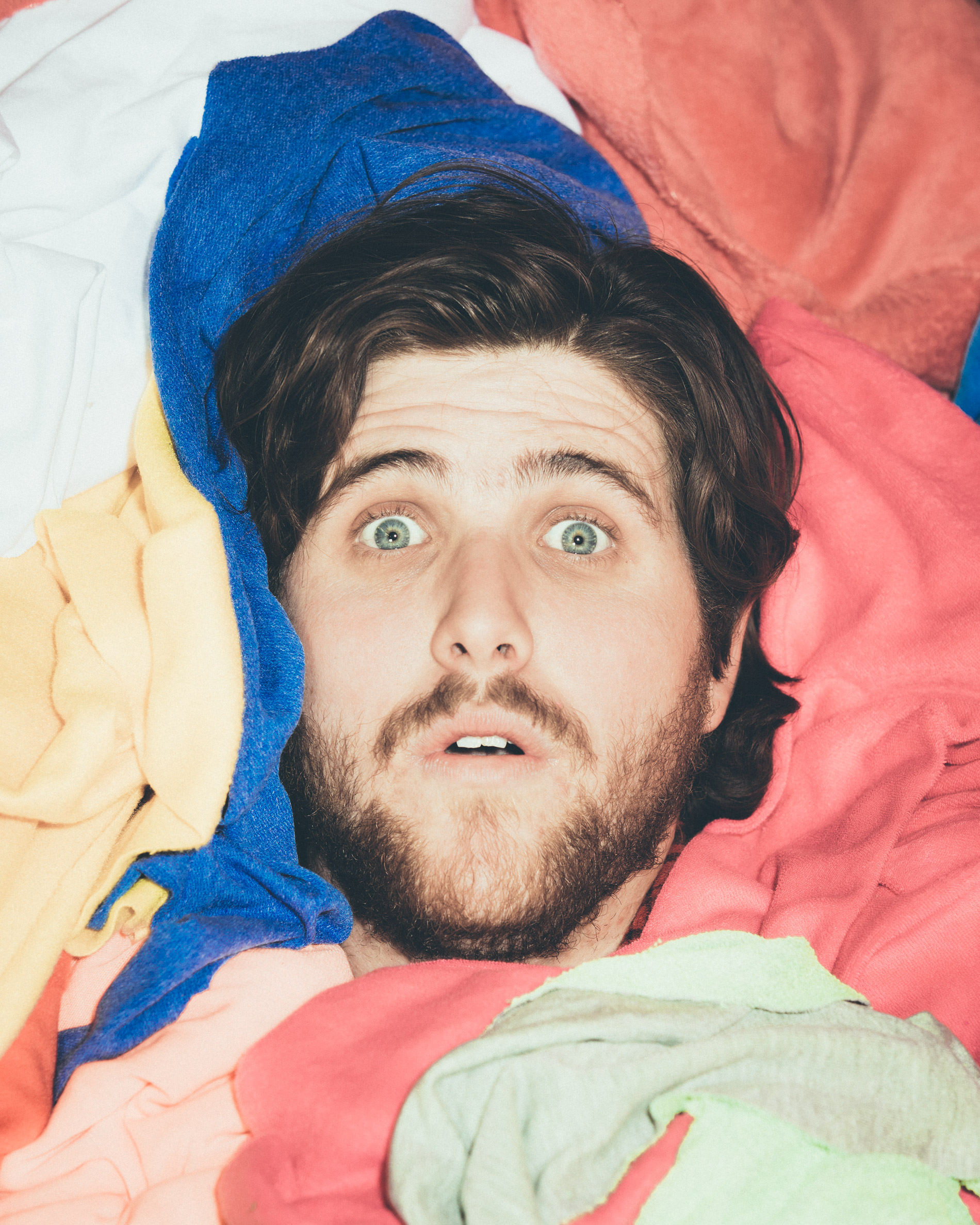 Jack Herzog surrounded by a bunch of fabric.