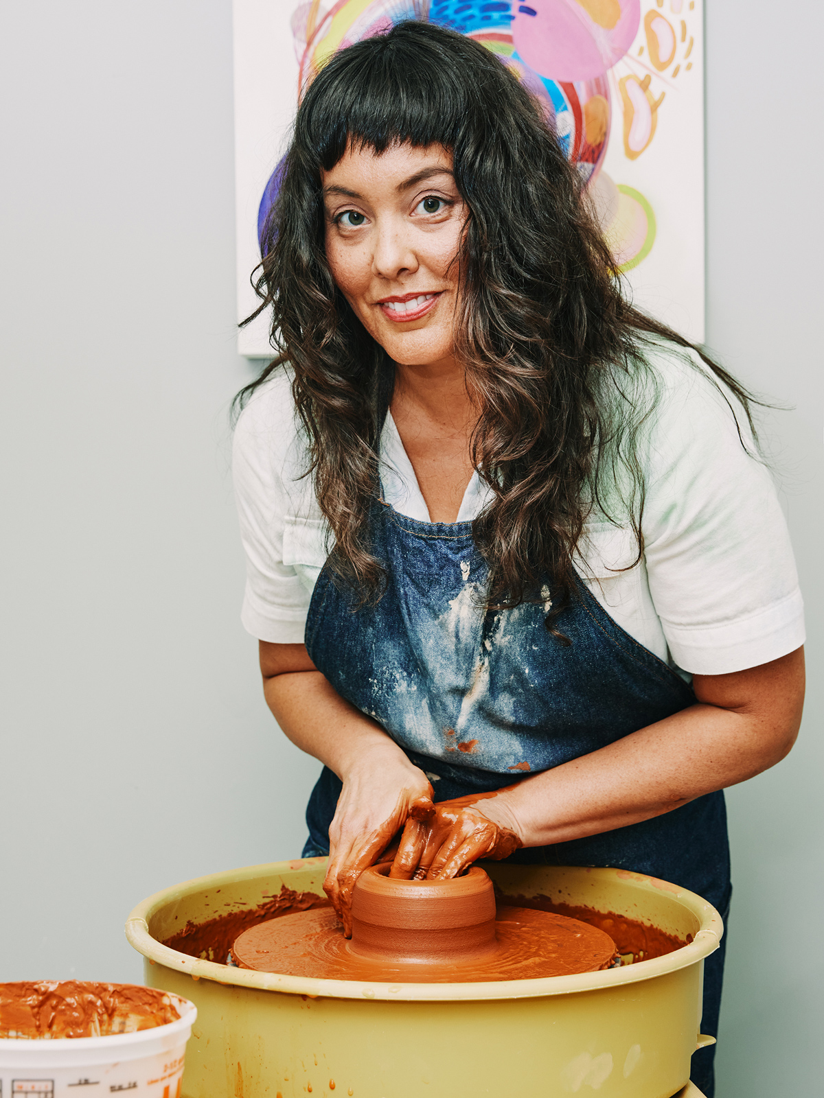 Angela Chvarak using the wheel in her studio.