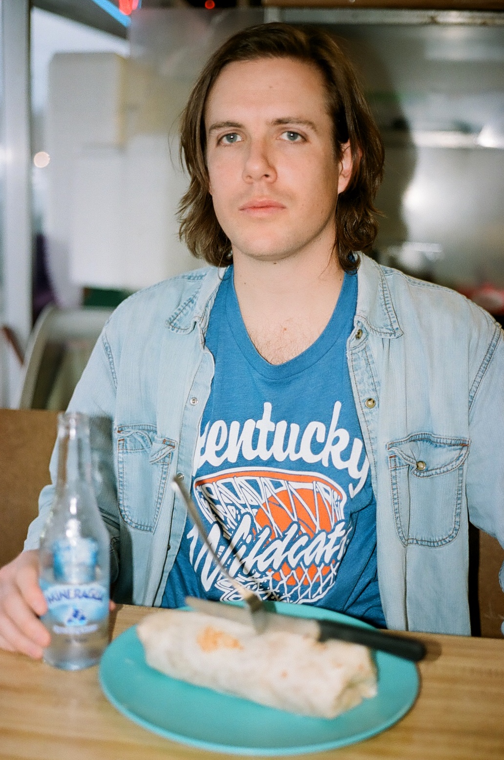 Photo of Case Mahan in a diner eating a burrito.