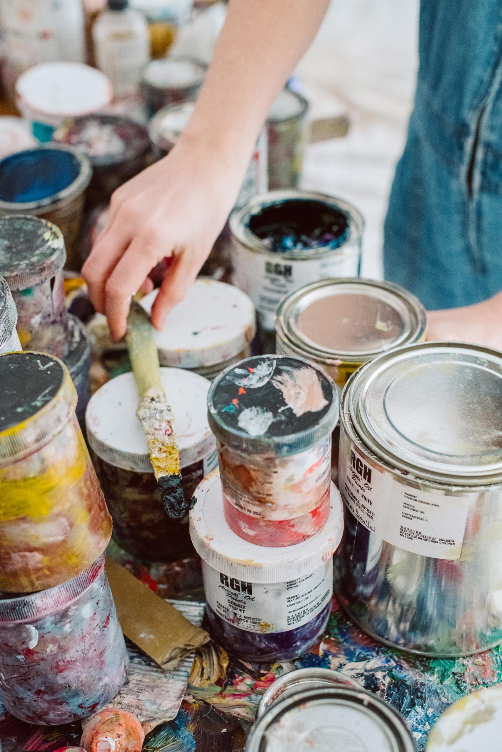 A table in Vanessa Prager's studio covered with small buckets of paint.