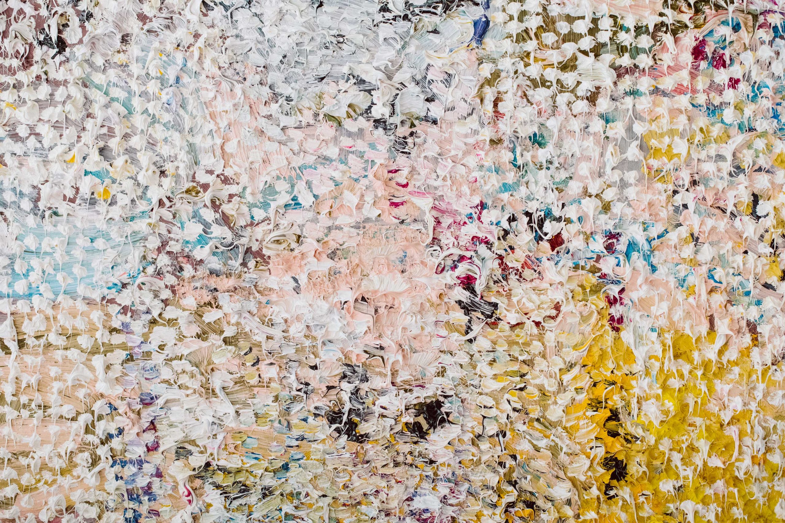 A close up image of a textured and multicolored painting.